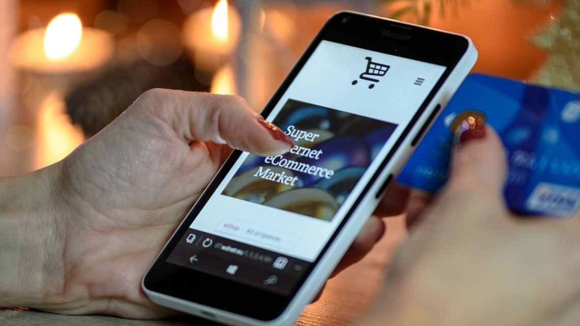 person scrolling through ecommerce site on phone