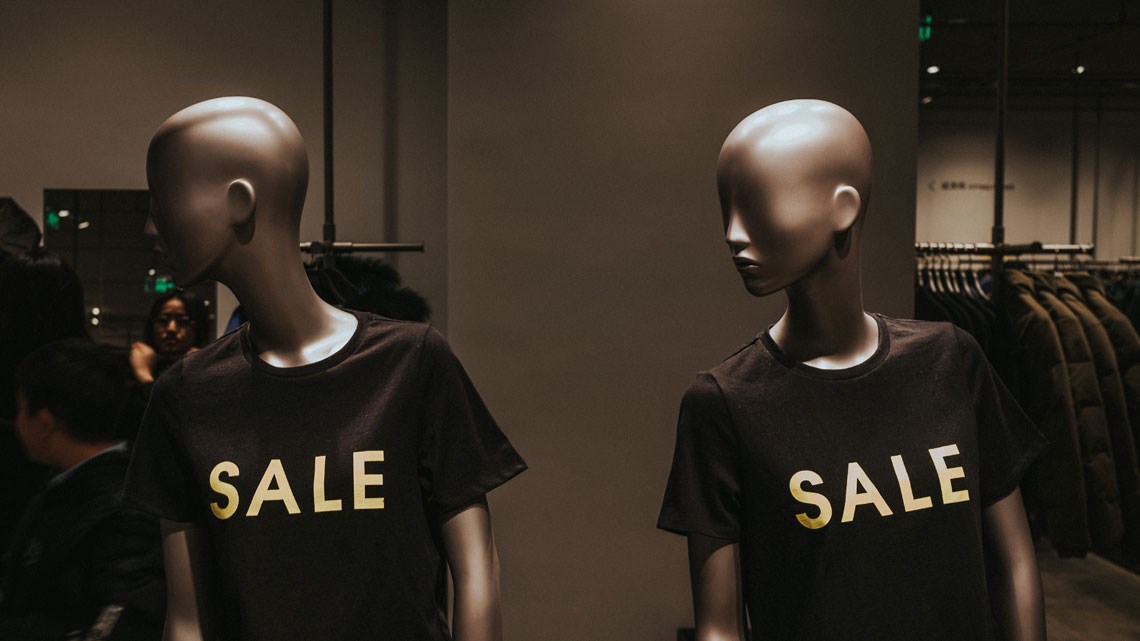 Two mannequins with sale t-shirts on