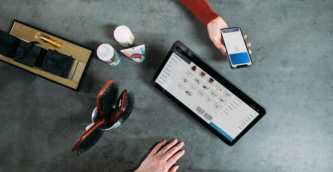 person using mobile payment on phone in a store