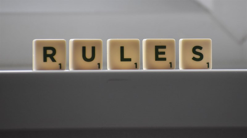 scrabble tiles spelling out the word rules