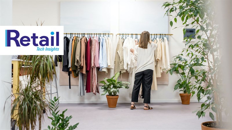 Woman browsing rail of clothes