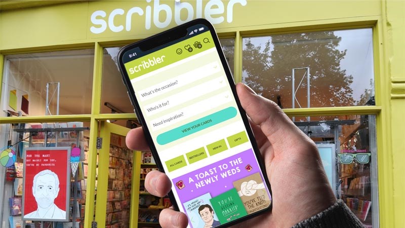 Scribbler ecommerce site on phone outside one of their stores