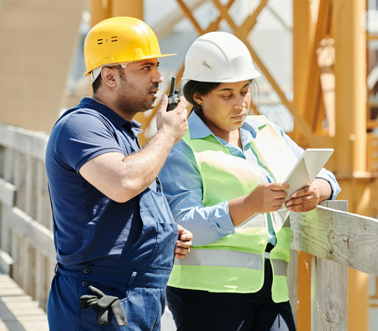 Builder and architect looking at blueprints