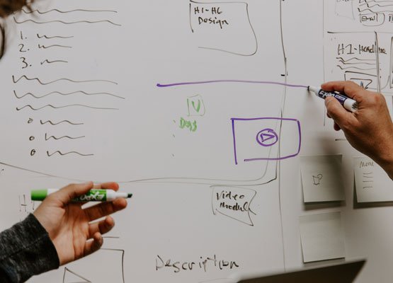 Person drawing on a whiteboard