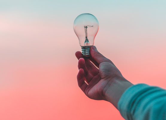 Person holding a lightbulb