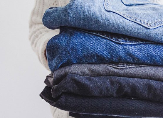 Person holding lots of jeans