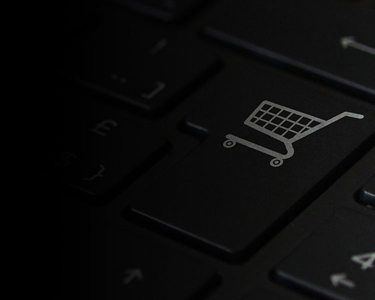 computer keyboard with ecommerce platform shopping cart icon on button