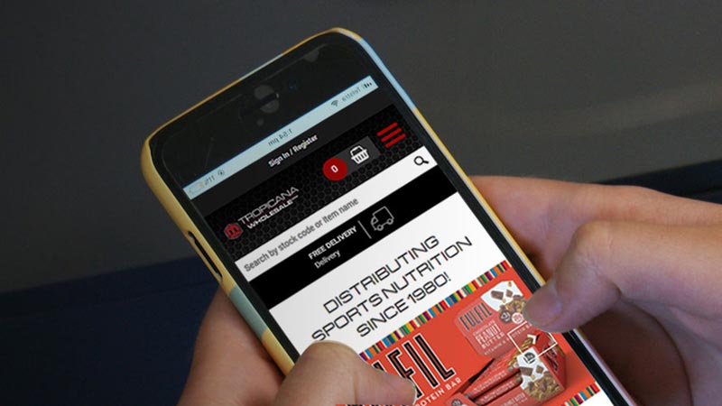 Tropicana Wholesale ecommerce site on a mobile phone